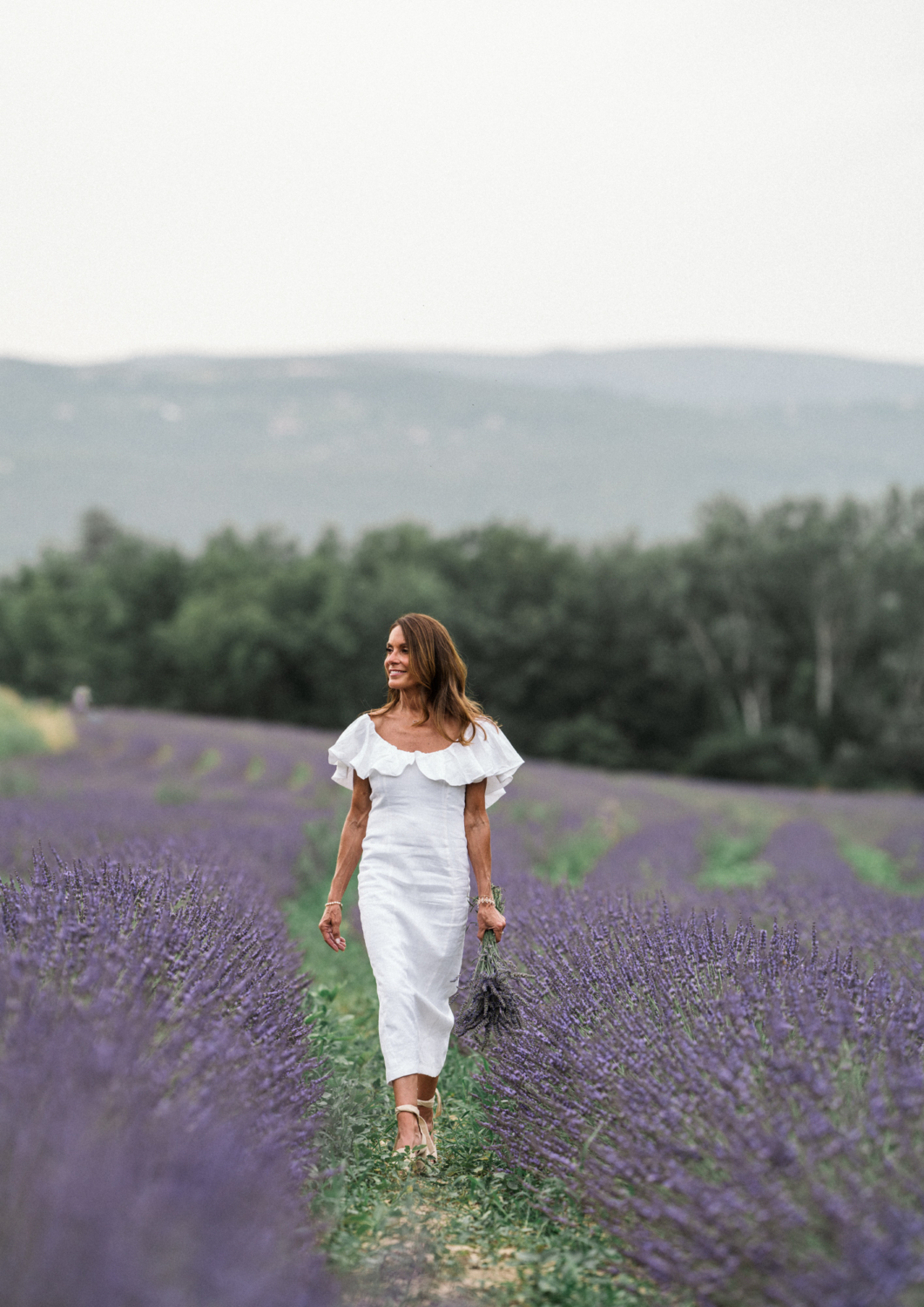 woman smiling walking in lavender field