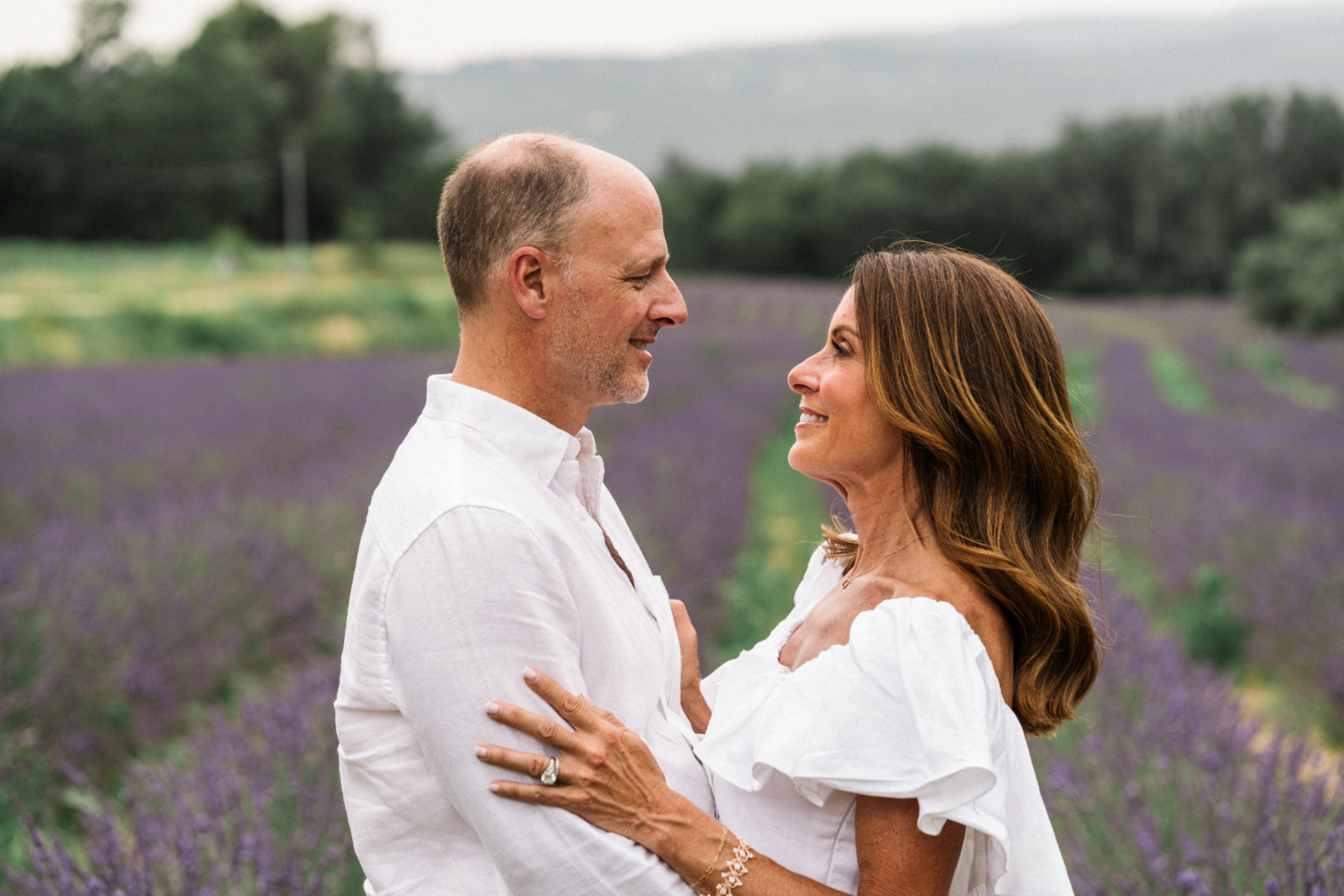 man and woman smile in lavender field