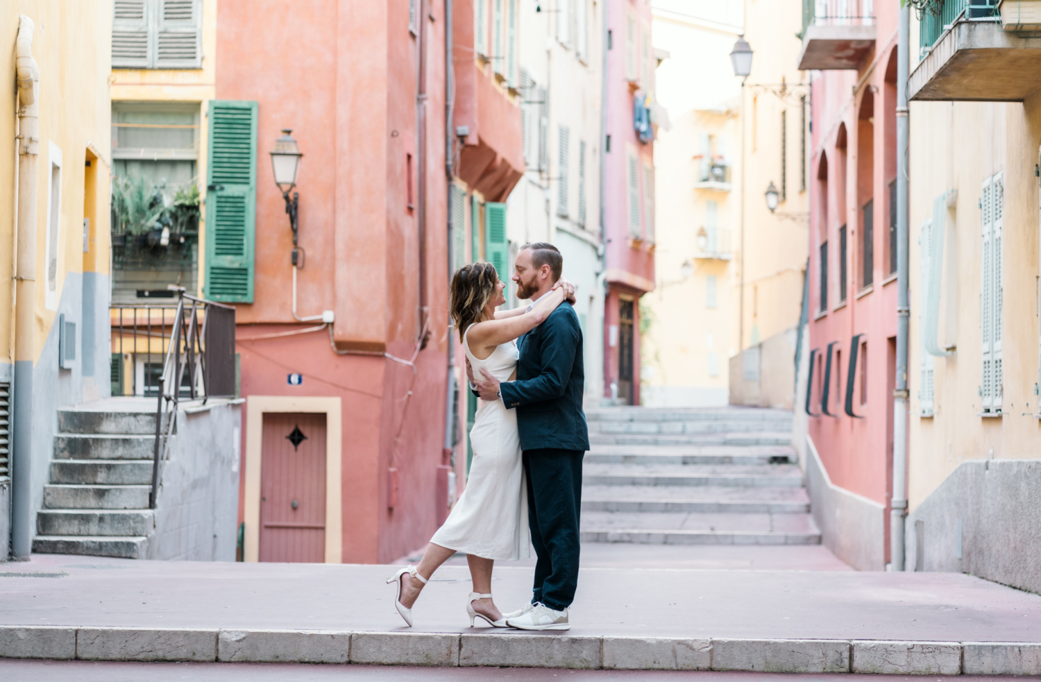 couple embrace with colorful background in nice france