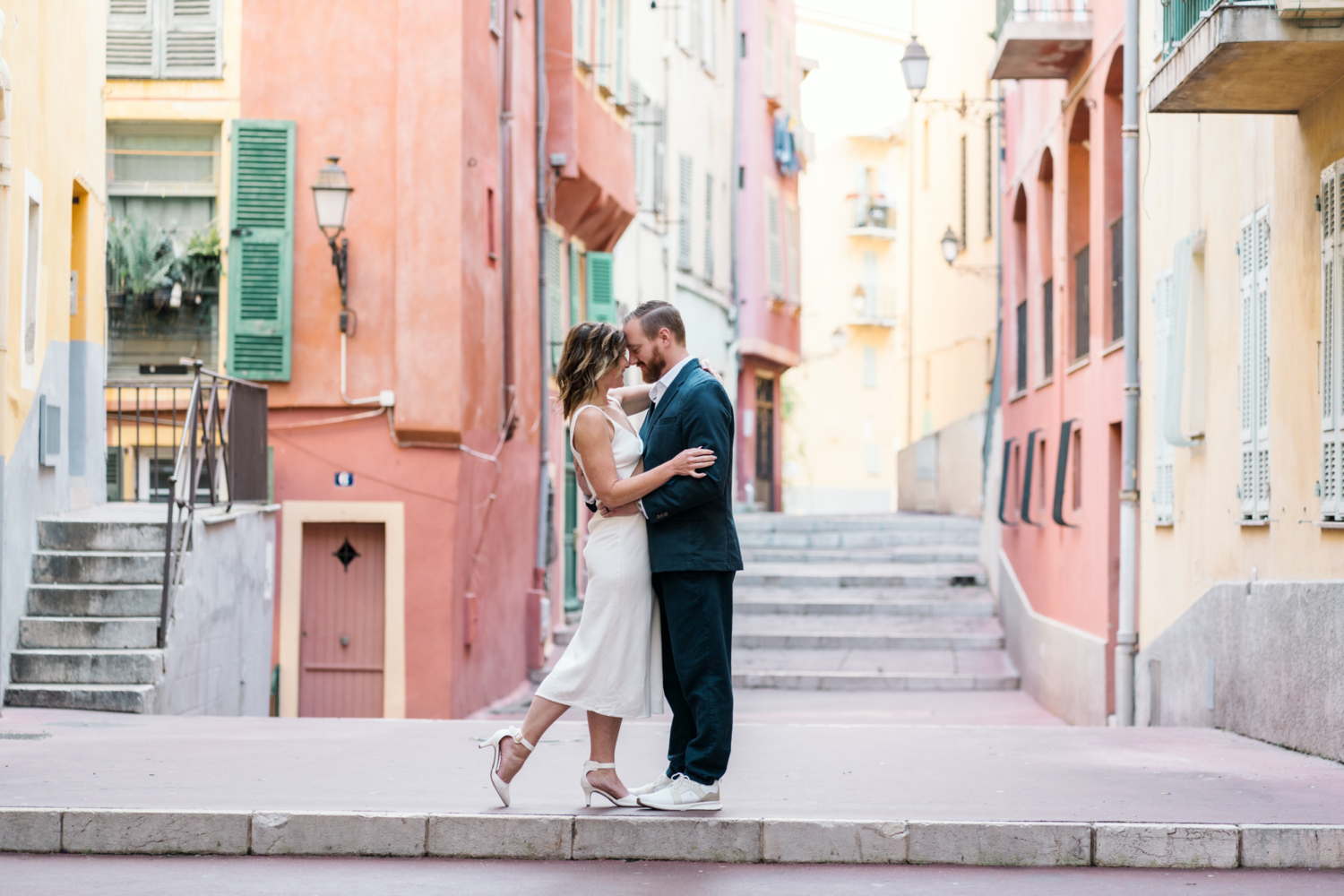 man and woman embrace tightly in old nice france