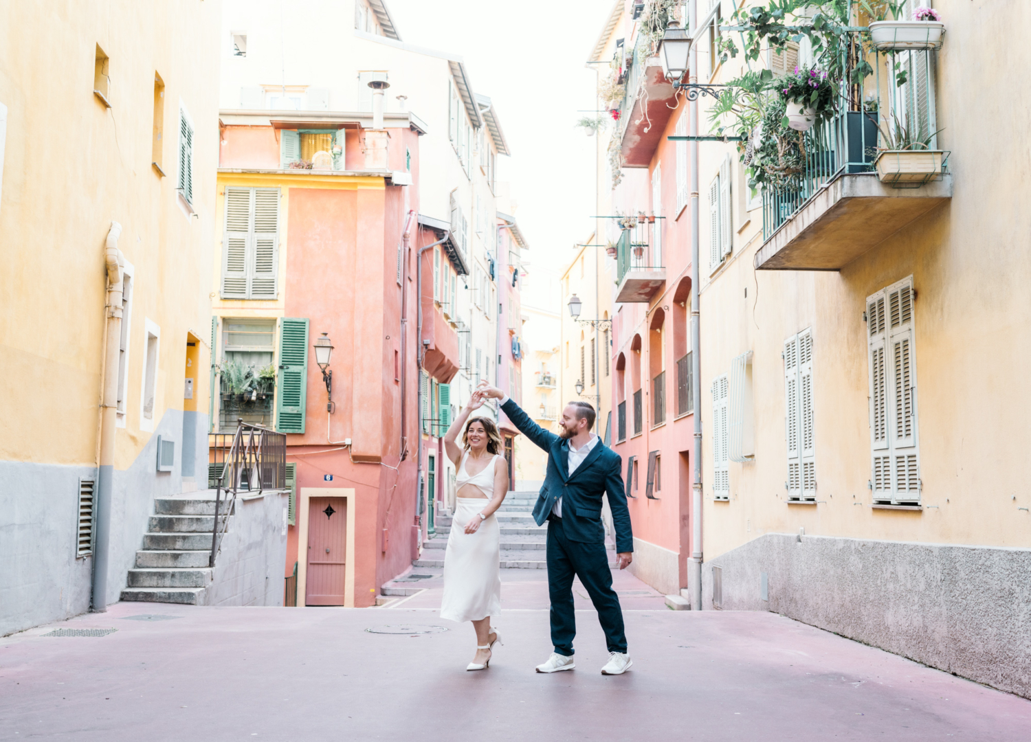 married couple dance in colorful neighborhood in nice france