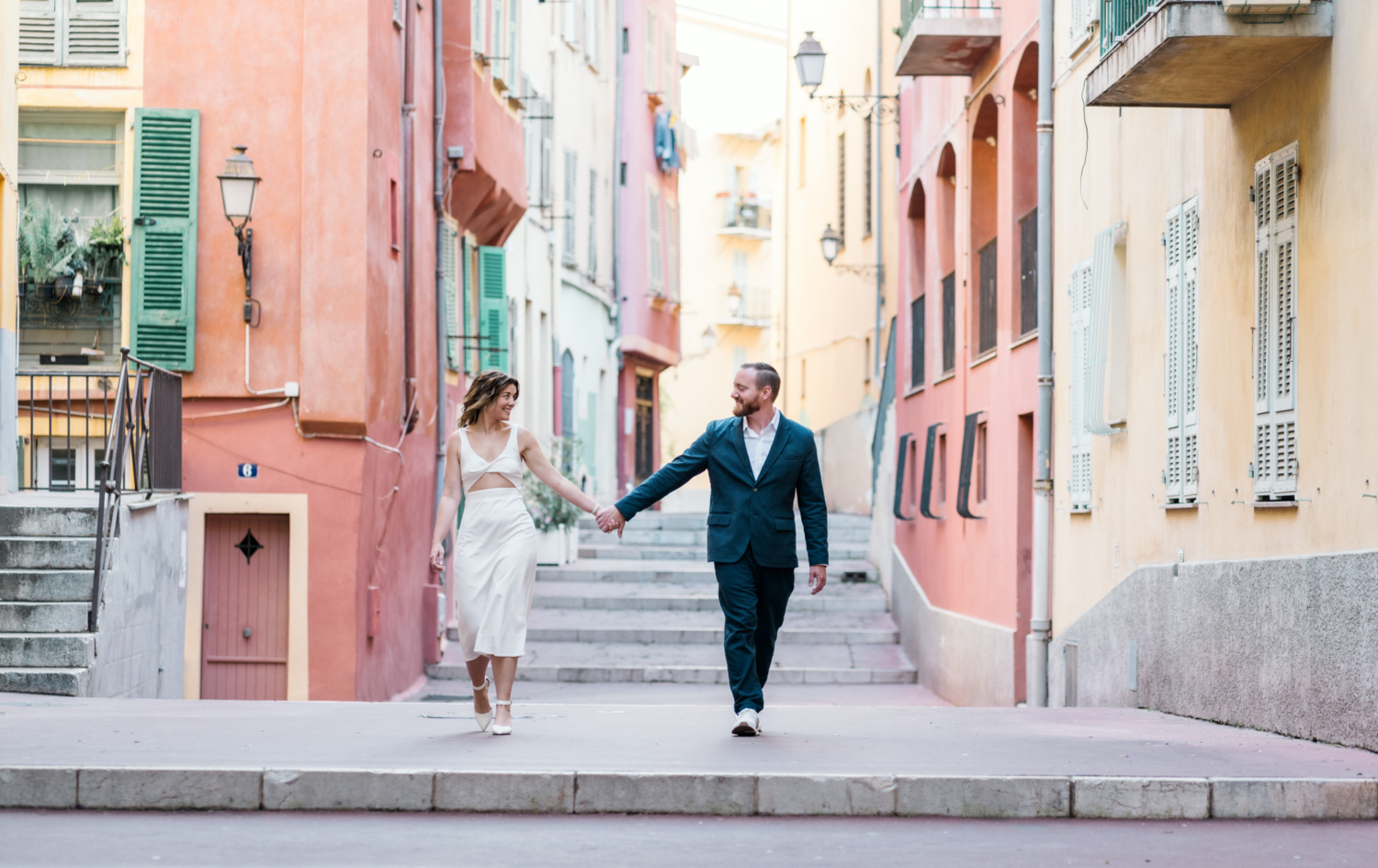 married couple laugh and walk in nice france