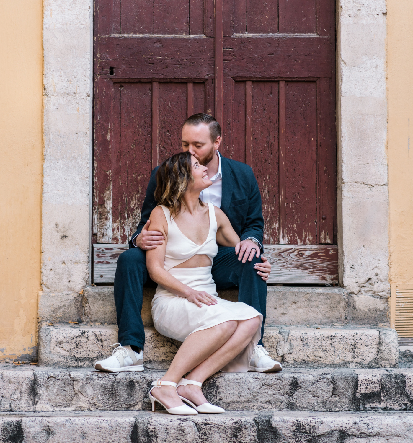 man and woman sit on old staircase in old nice france