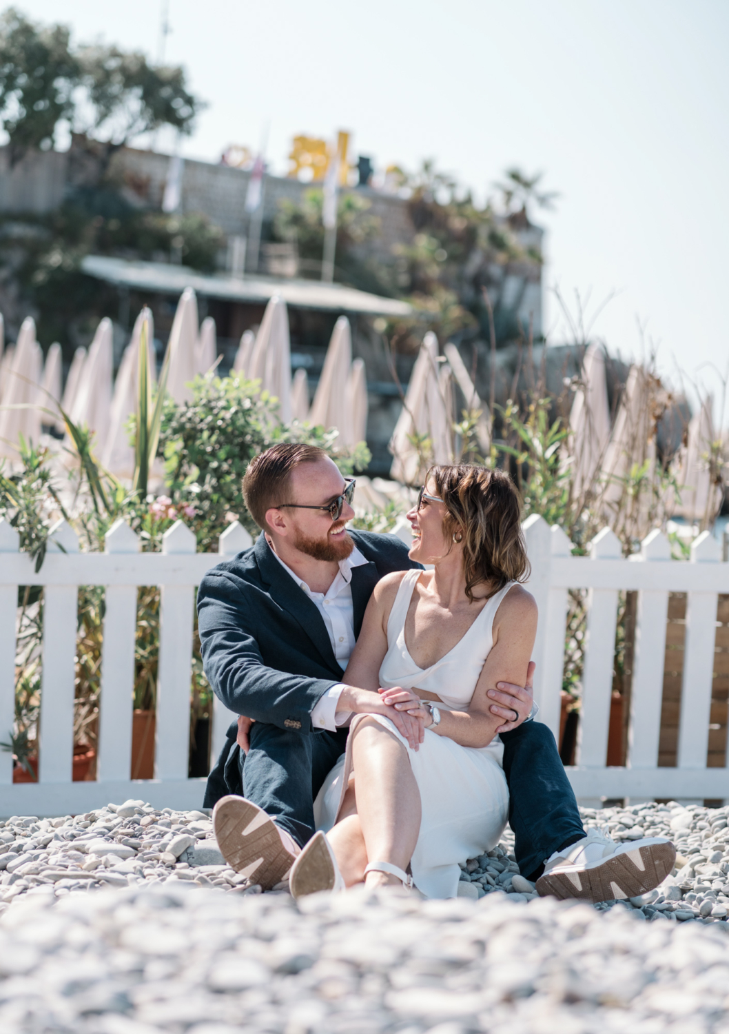 happy couple laugh on the beach in nice france