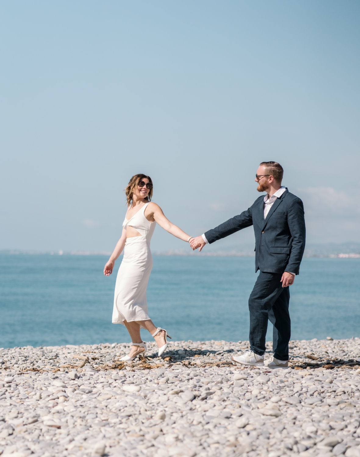 cute couple walk on the beach in nice france