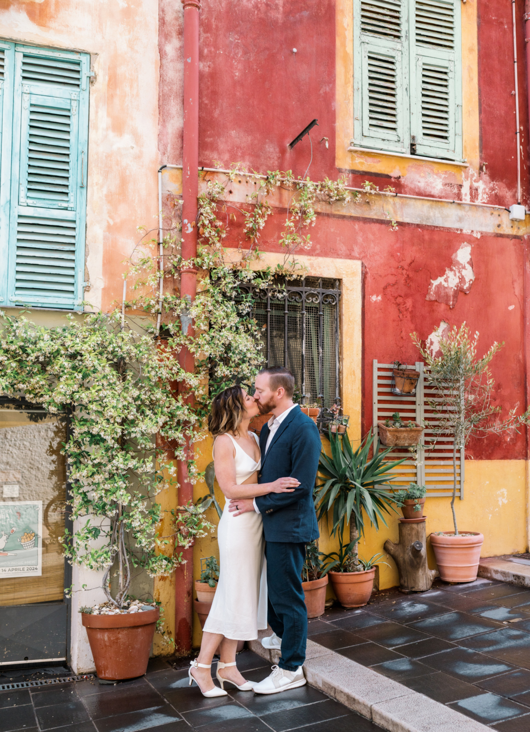 married couple kiss passionately in colorful neighborhood in nice france