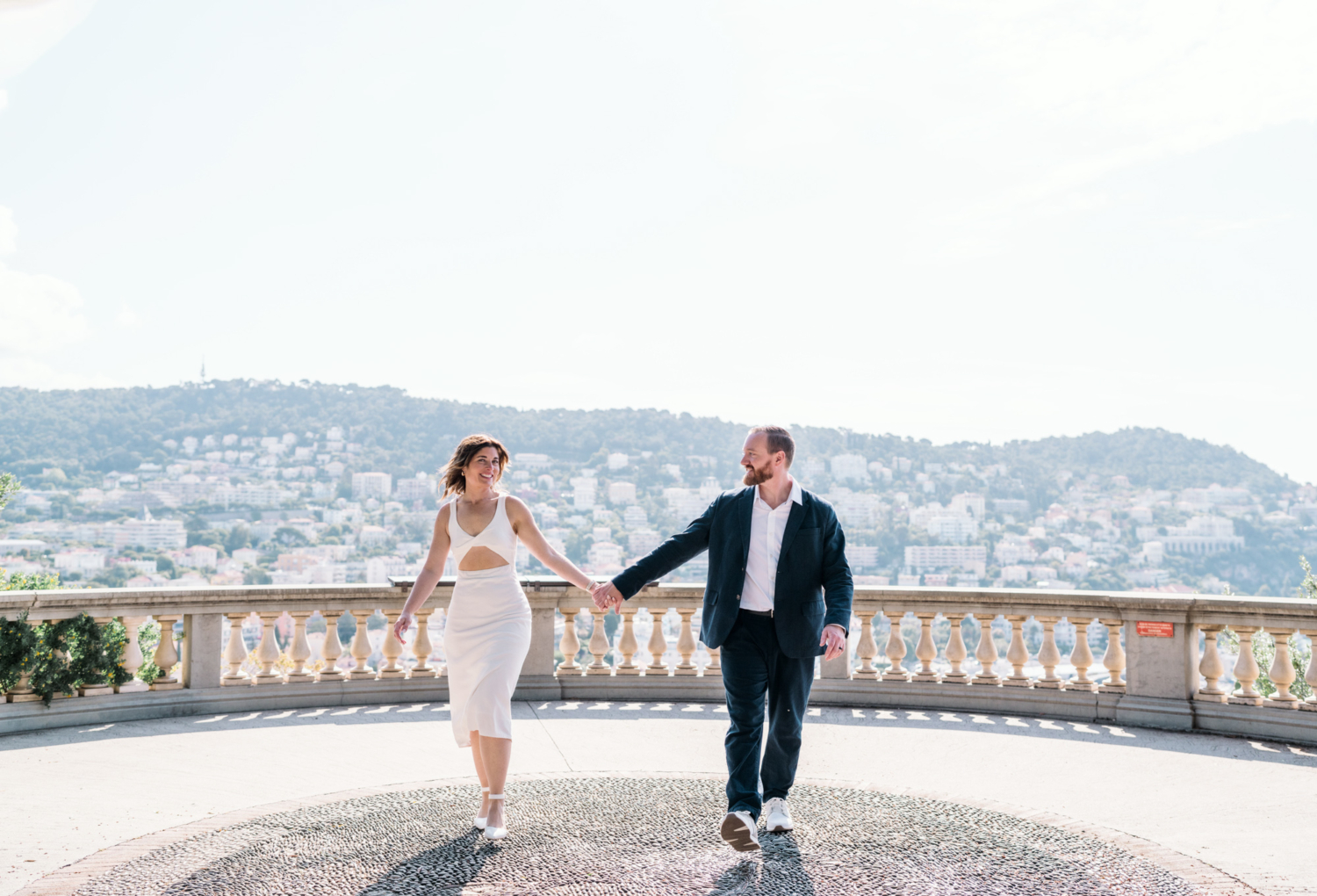 happy couple walk at castle hill in nice france