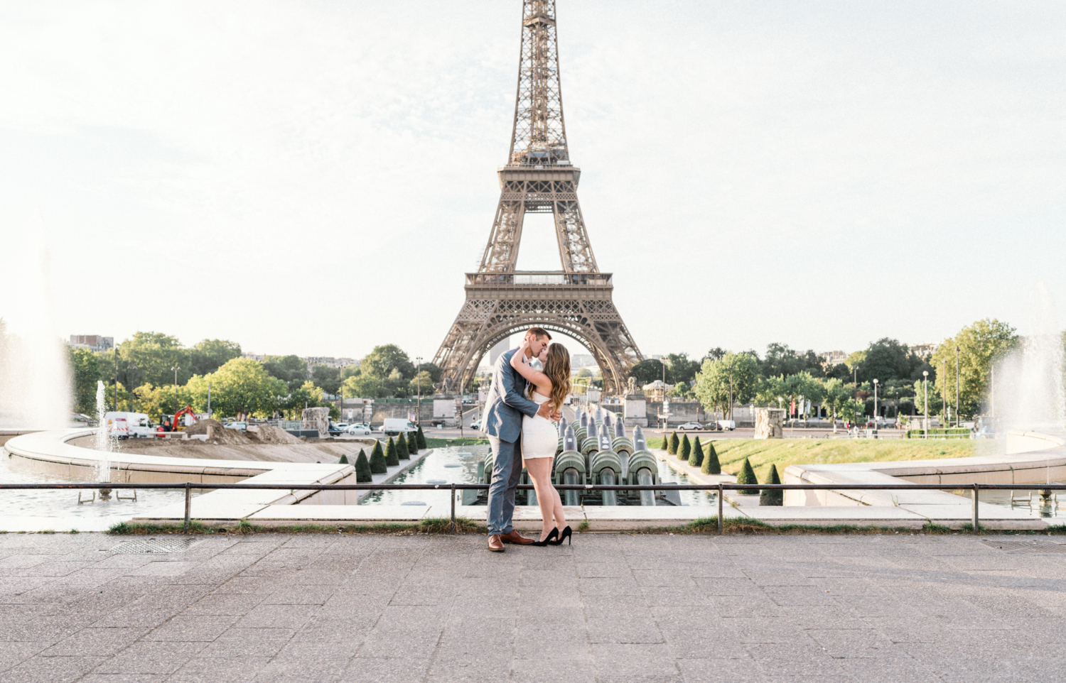 engaged couple embrace at trocadero eiffel tower paris