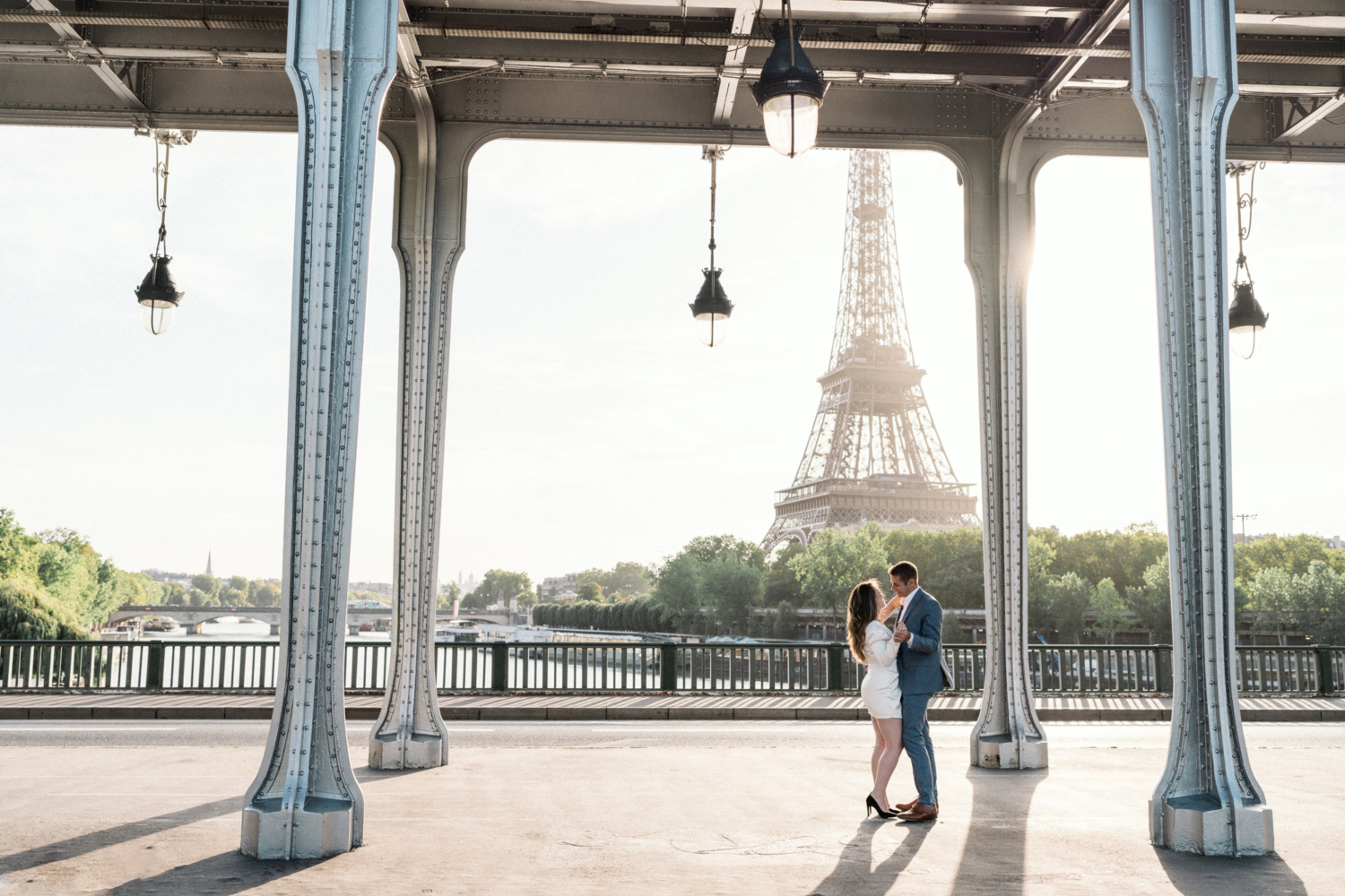 engaged couple dance under bir hakeim bridge in paris