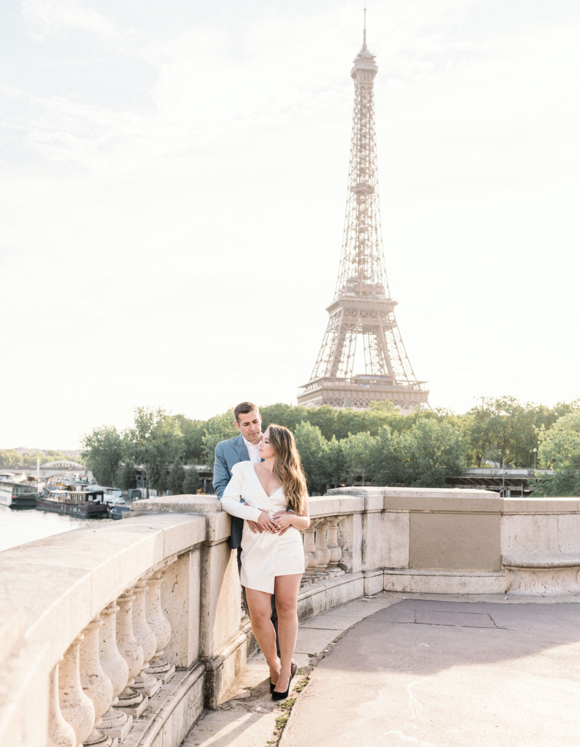 engaged couple pose at the eiffel tower in paris