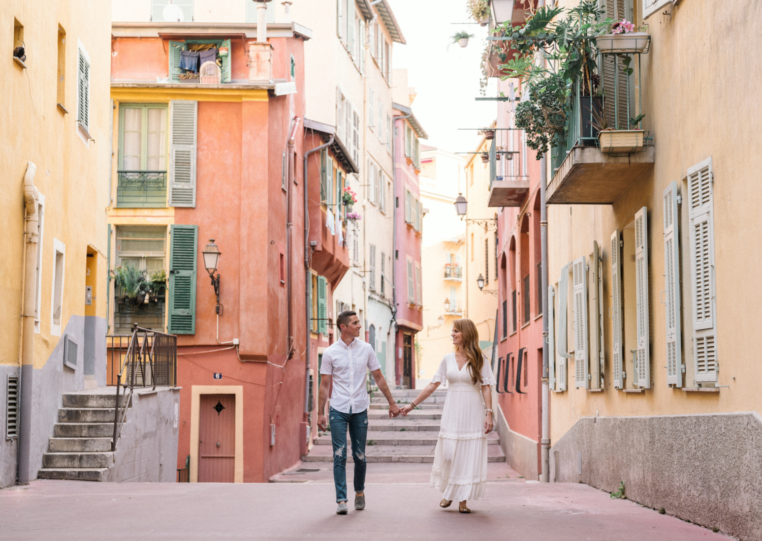 happy couple walk together in colorful old town nice france