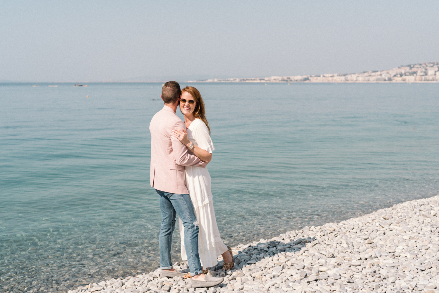 couple embrace next to sea in nice france