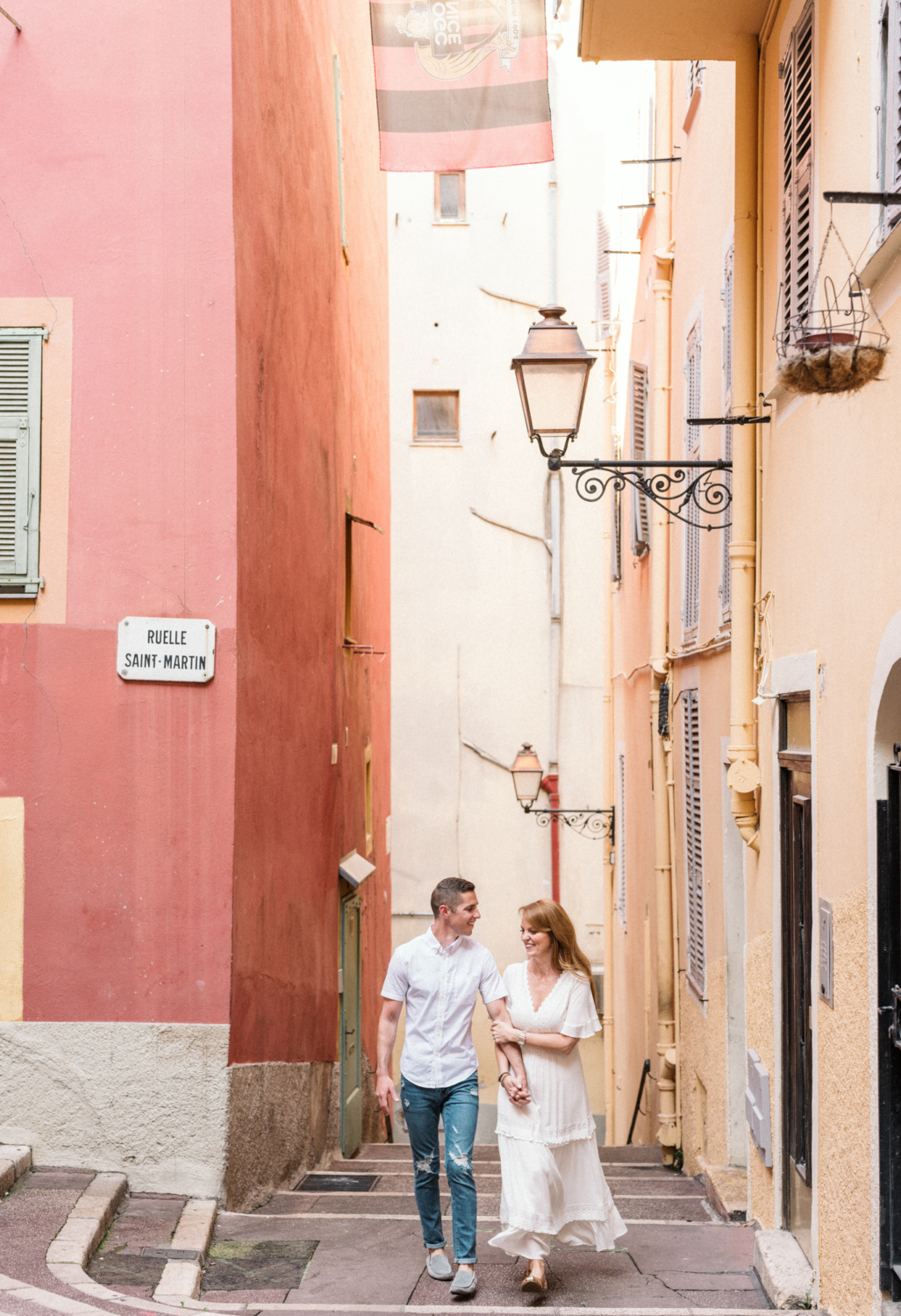 cute couple walk arm in arm in nice france