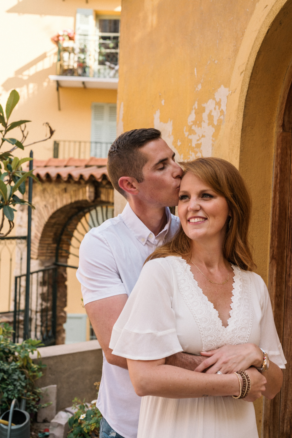 husband kisses wife's forehead in nice france