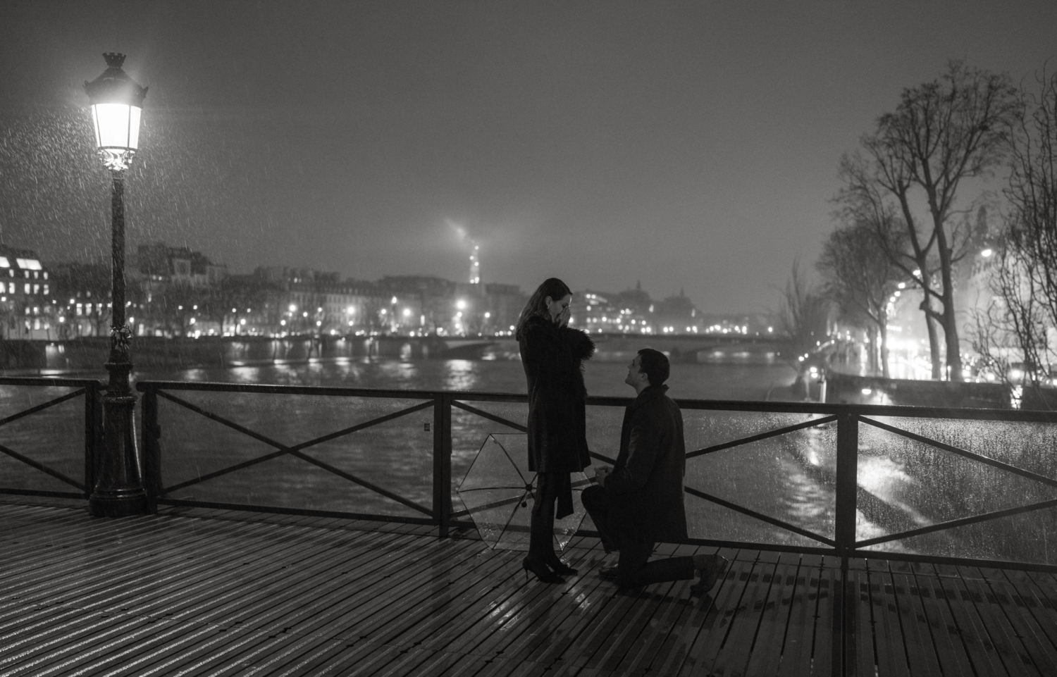 man on one knee proposes in paris at night