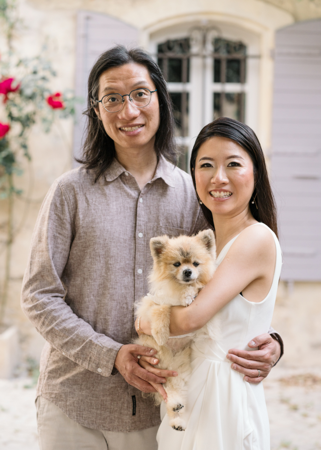 beautiful chinese couple hold Pomeranian dog and pose in arles france