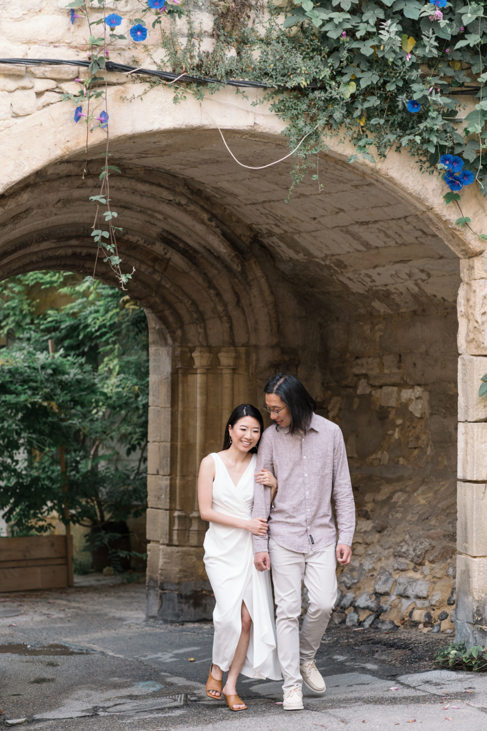 married chinese couple walk in ancient arles france