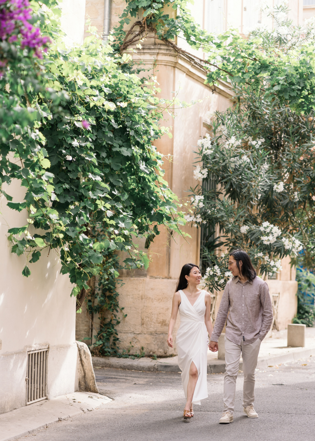 cute chinese couple hold hands in arles france