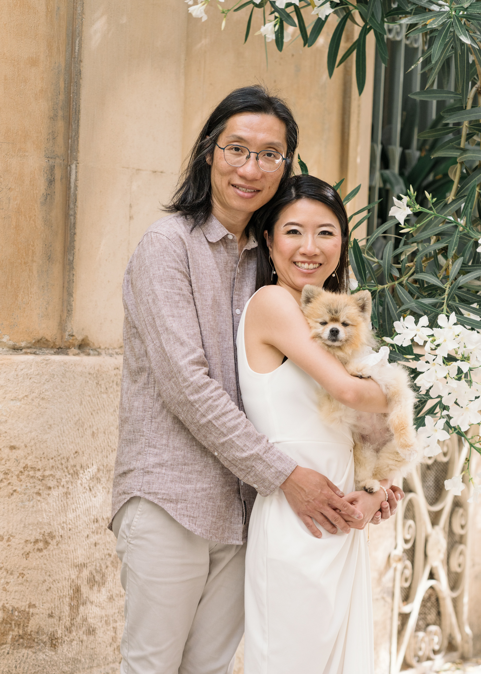 cute chinese couple hold Pomeranian dog in arles france