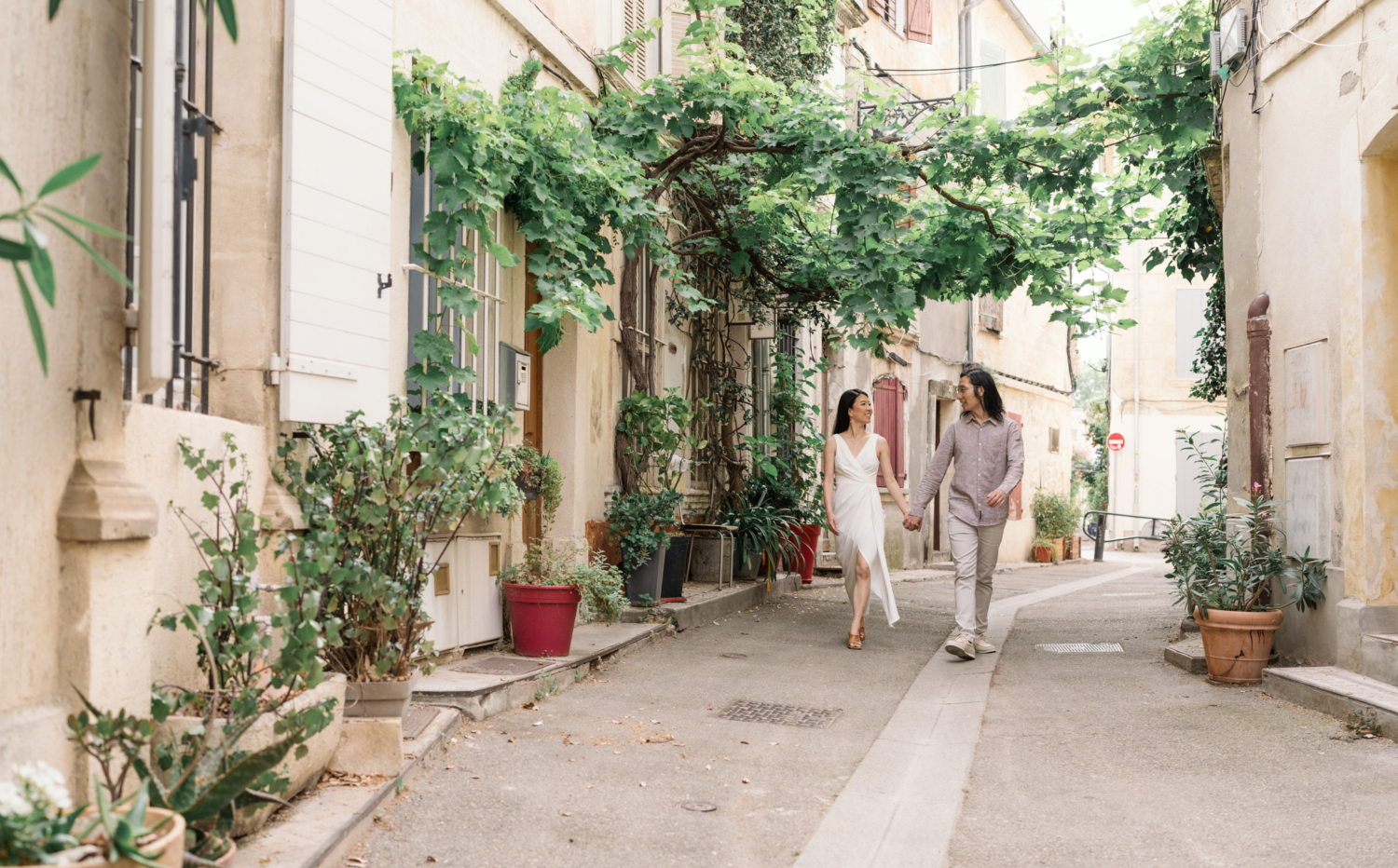 chinese couples walk and smile on beautiful street in arles france