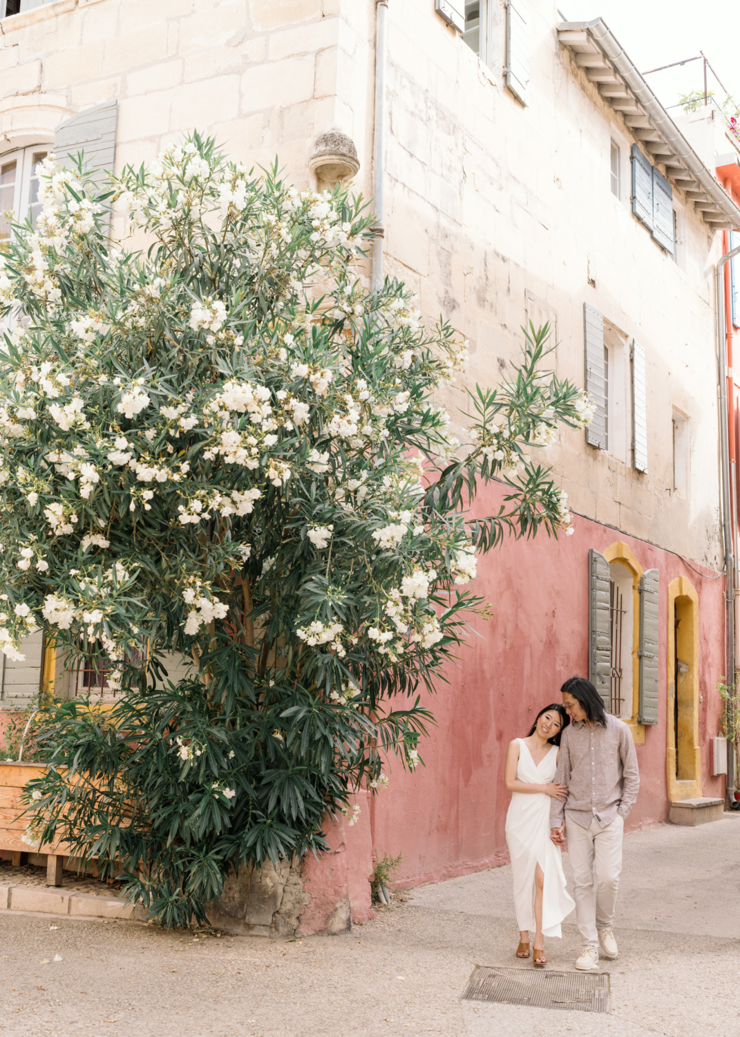 beautiful couple walk together in colorful neighborhood in arles france