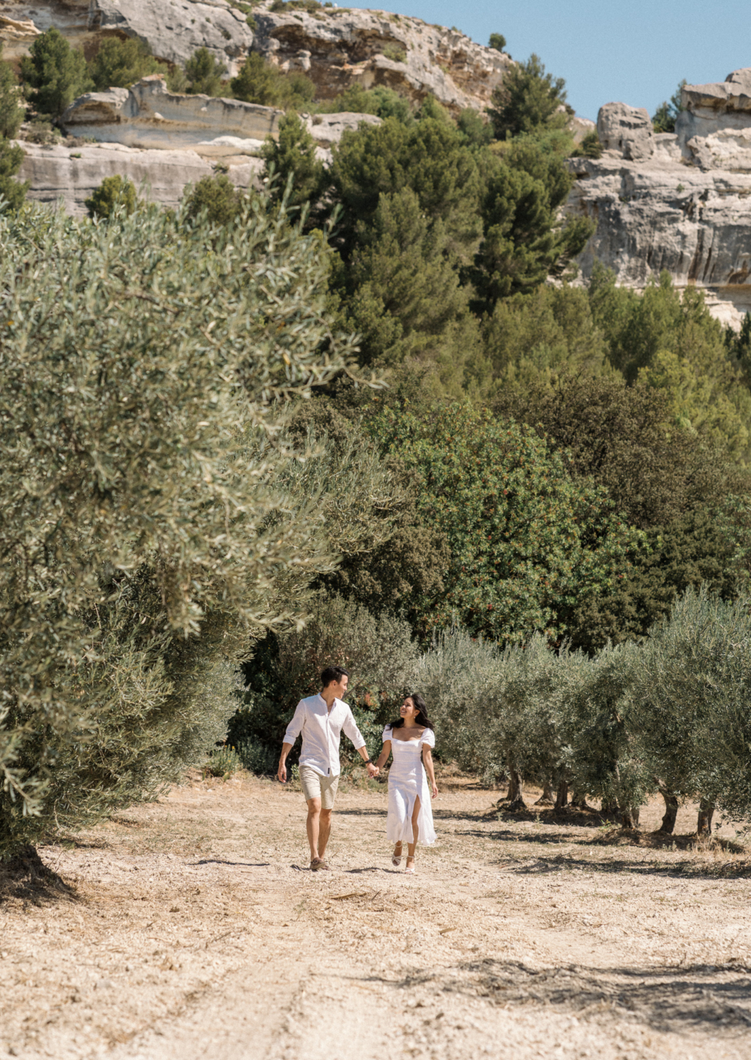 couple walk on dirt road in les baux de provence