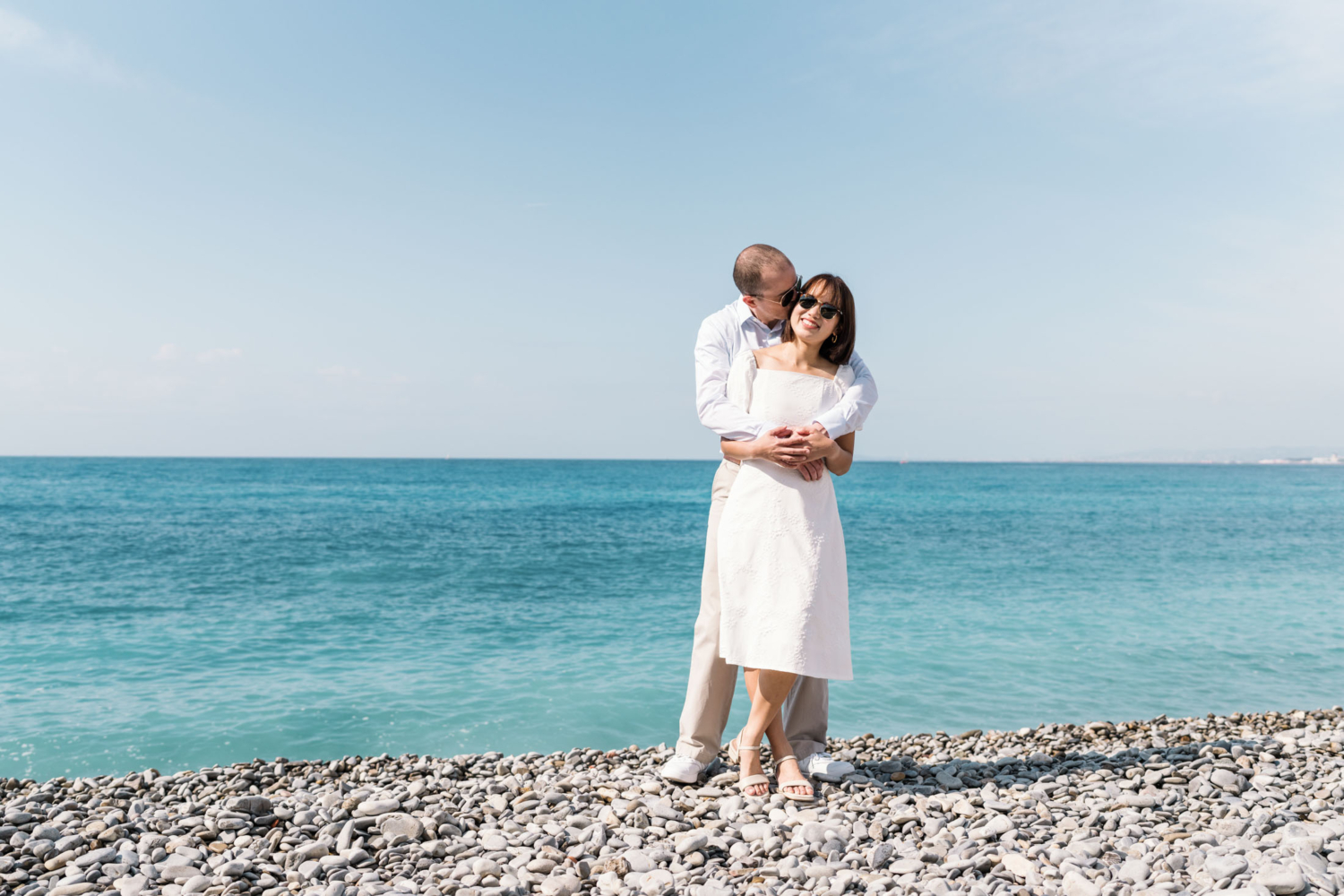 man kisses womans face at the beach in nice france