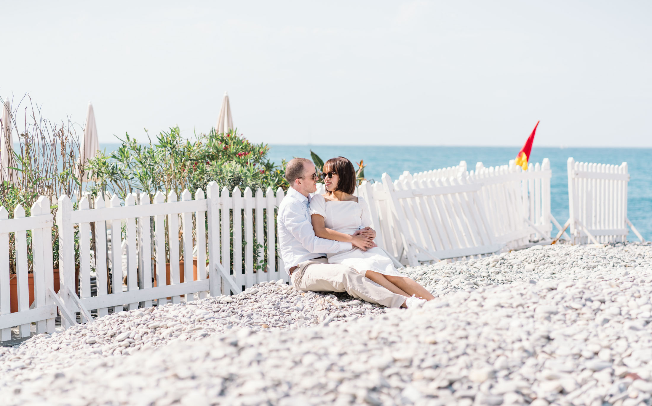 cute couple sitting on the beach in nice france