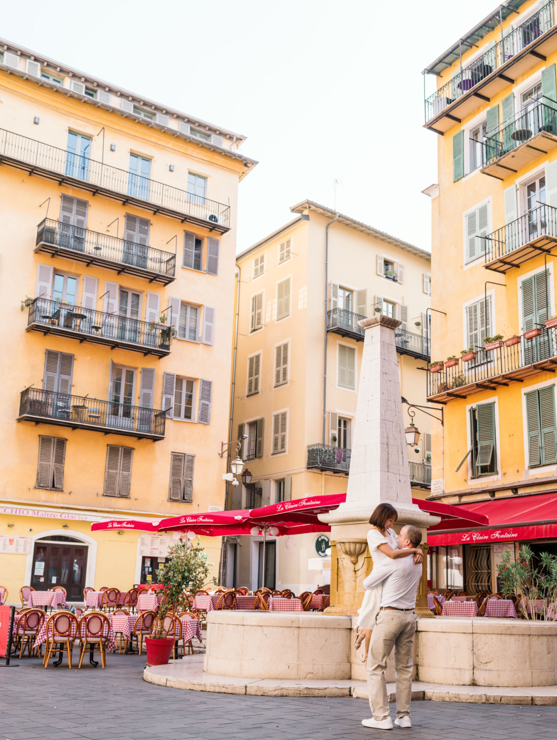 man lifts woman in air near italian restaurant in nice france