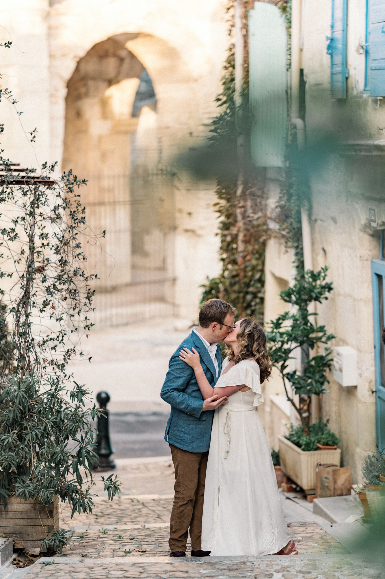 man and woman kiss on stairs in arles france