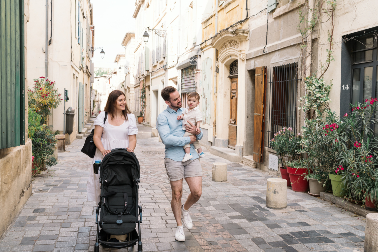 baby with his parents walk streets in arles france