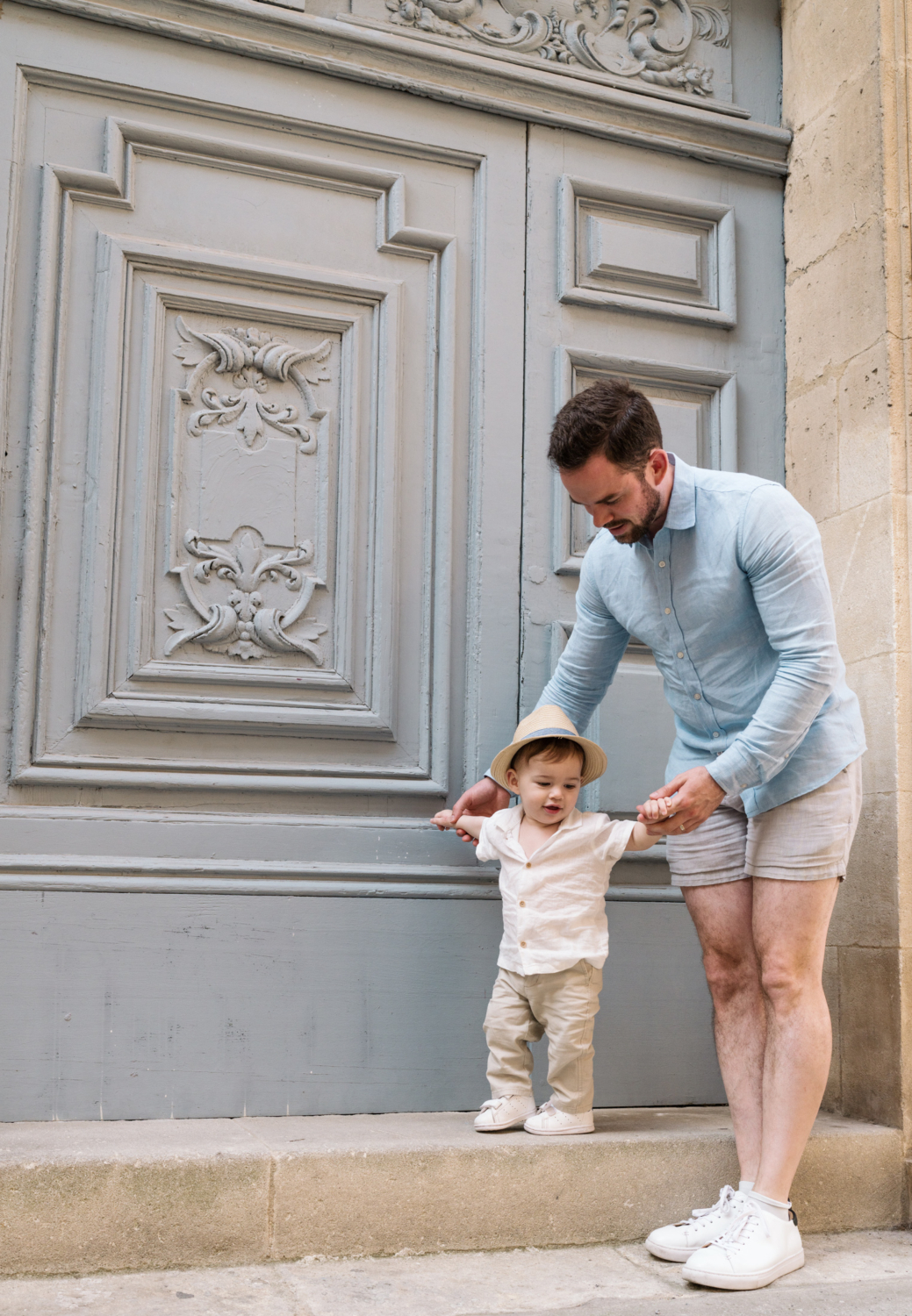 little boy walks with his dad in arles france