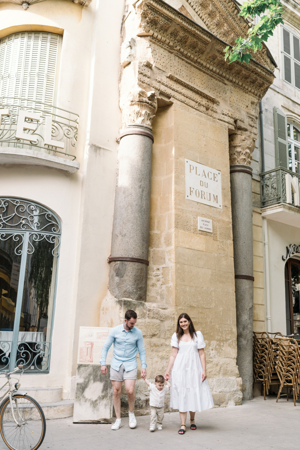 young parents walk at place du forum in arles france