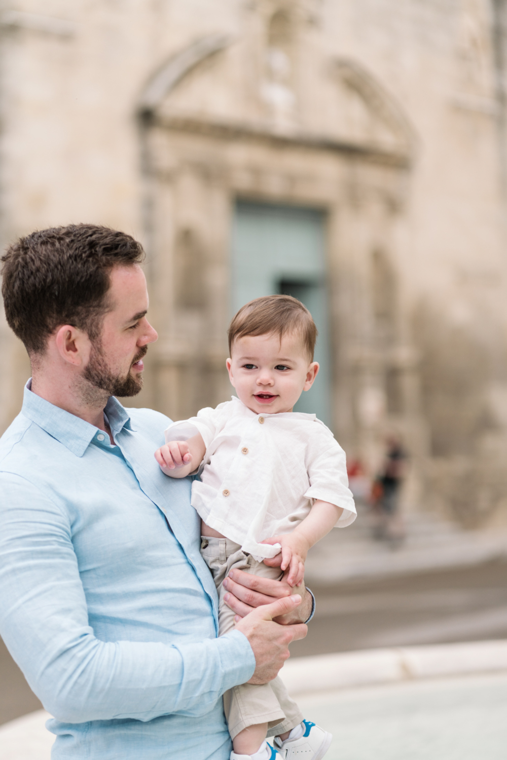 little boy smiles being held by dad in arles france