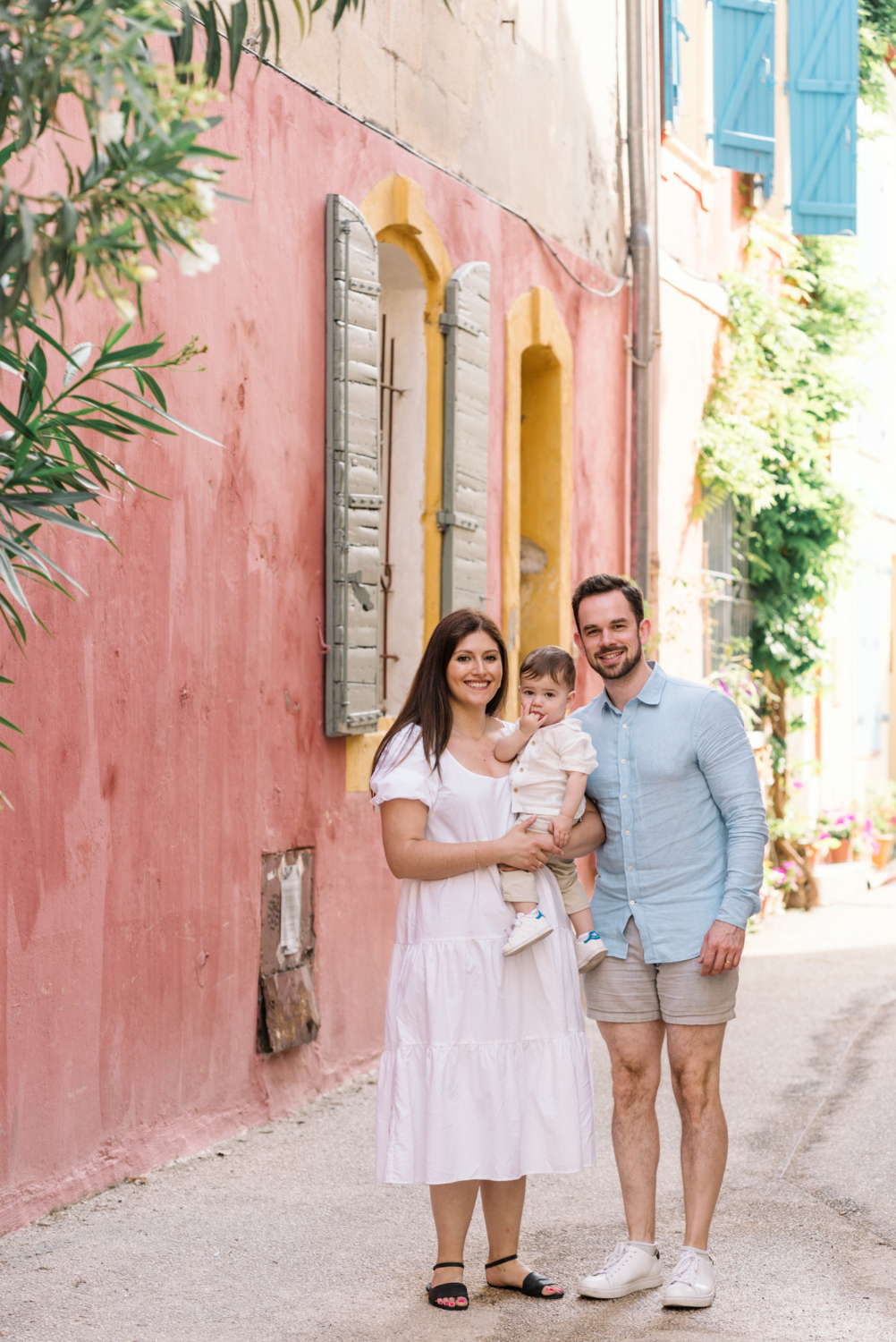 cute young family pose in colorful neighborhood in arles france