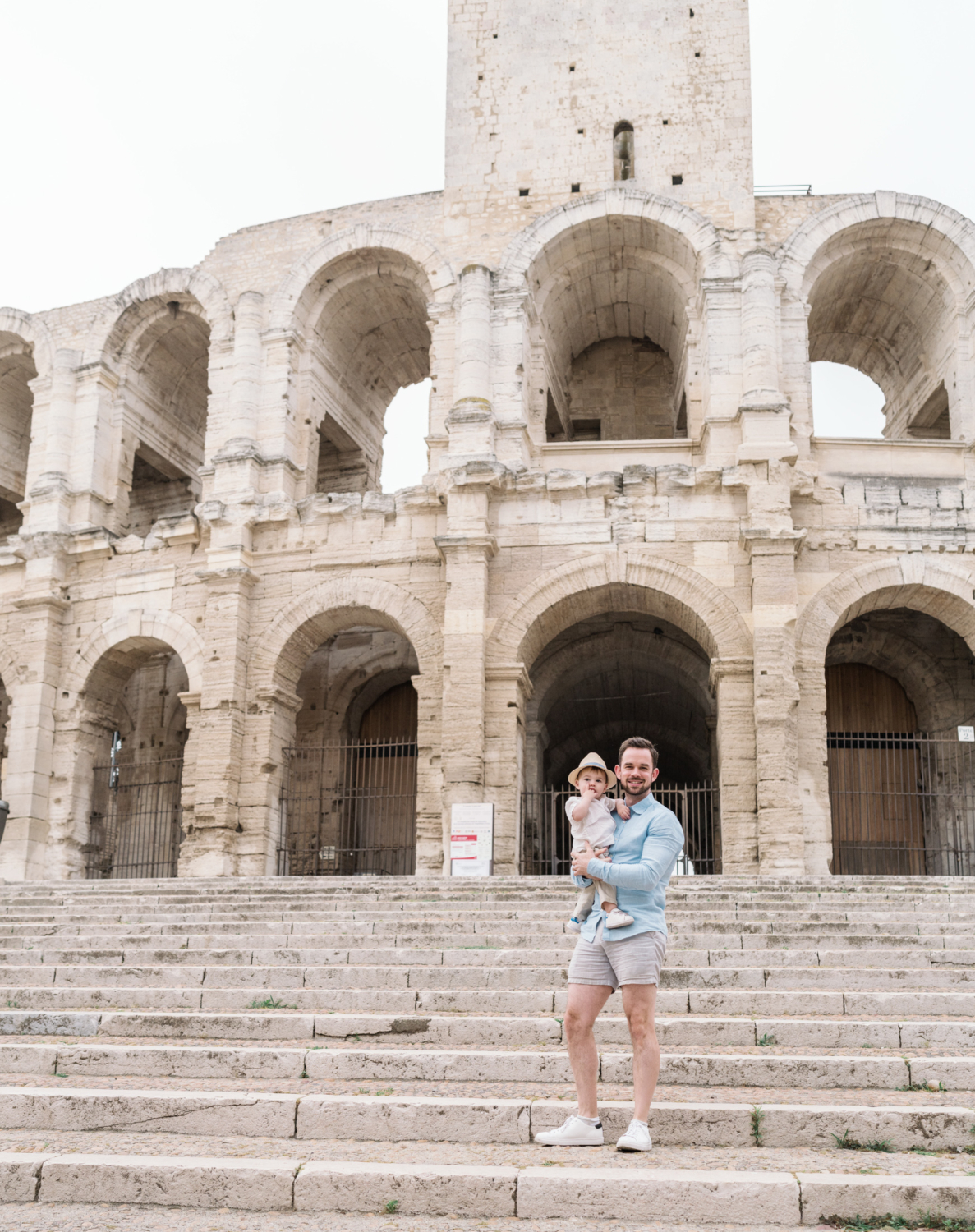 dad and his baby pose at roman amphitheater in arles france