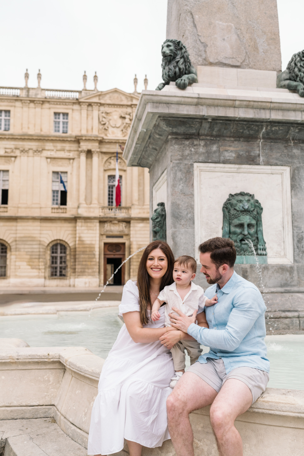 young family pose at fountain in arles france