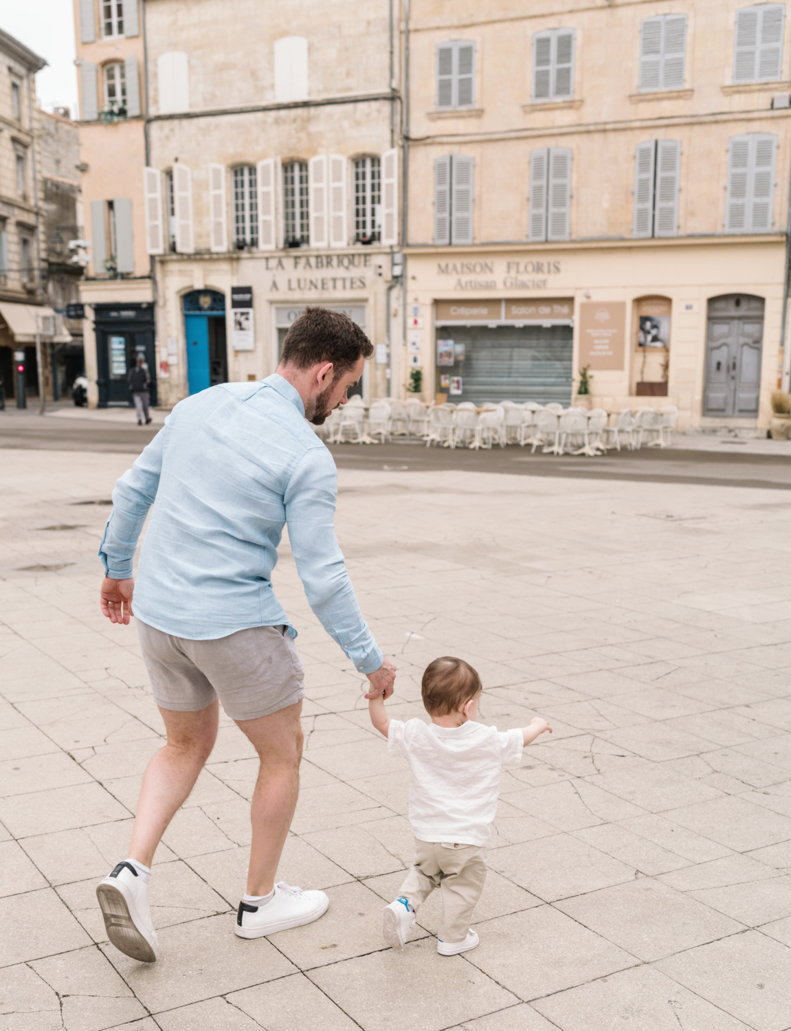 little boy runs with his dad in arles france