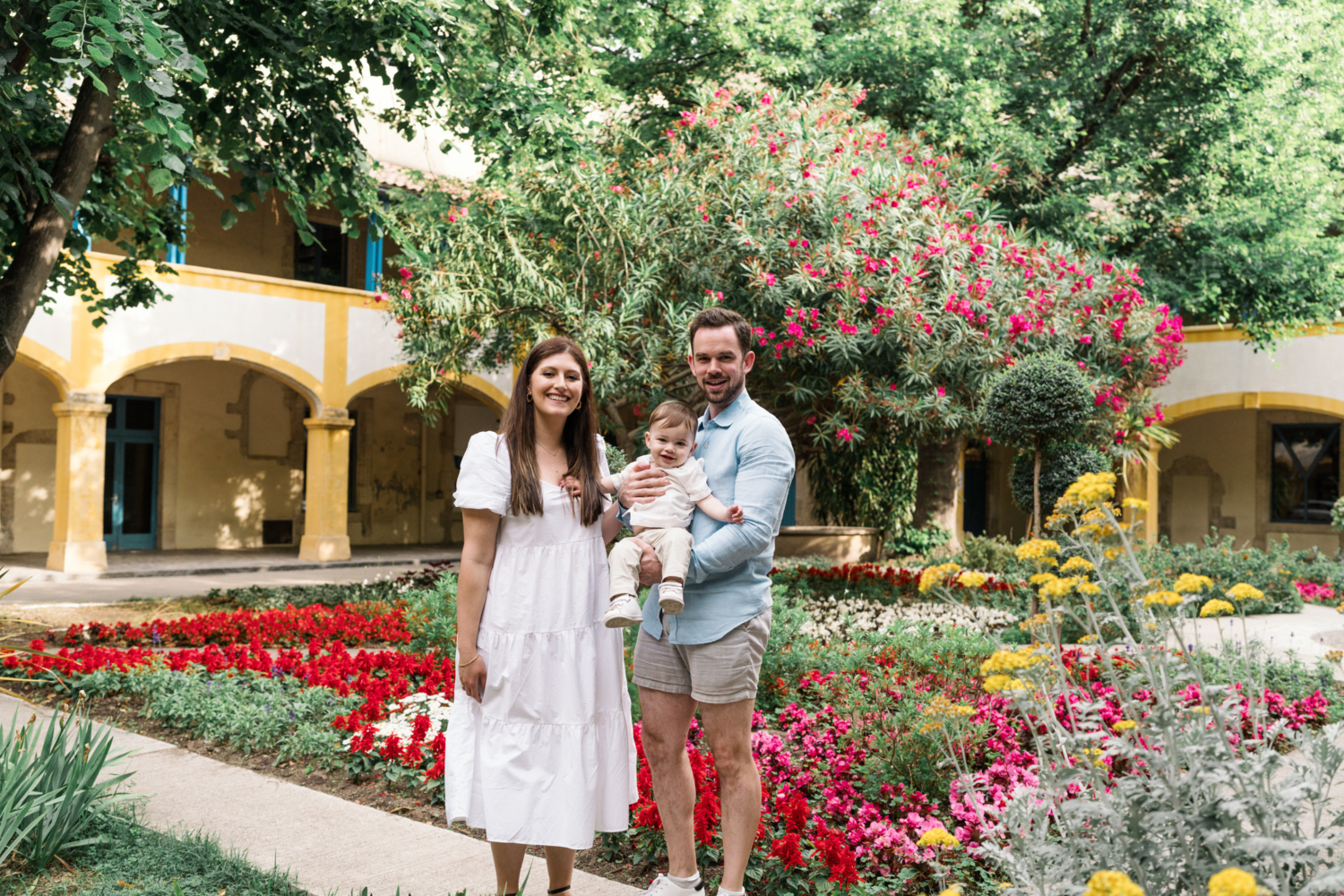 young family pose in garden in arles france