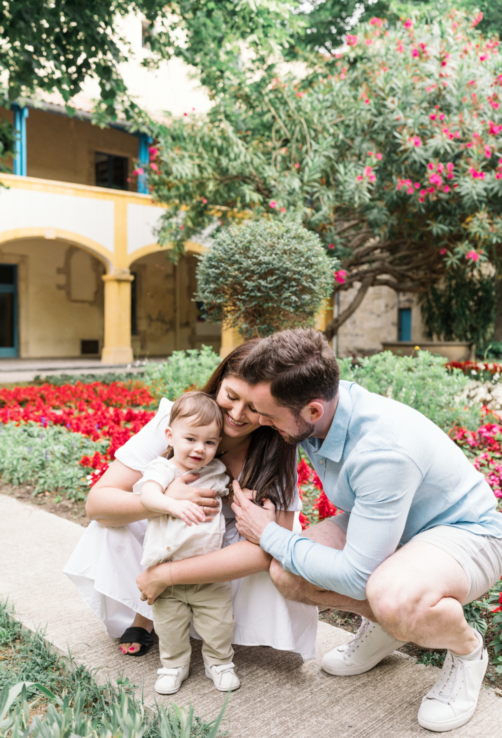 young family pose with baby in garden in arles france