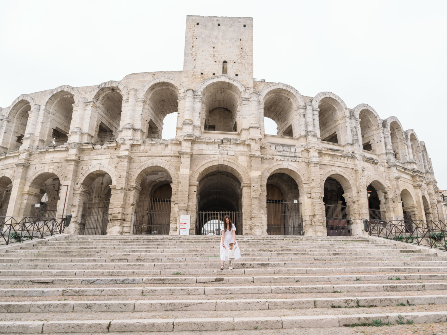 mom walks with baby at roman amphitheater in arles france