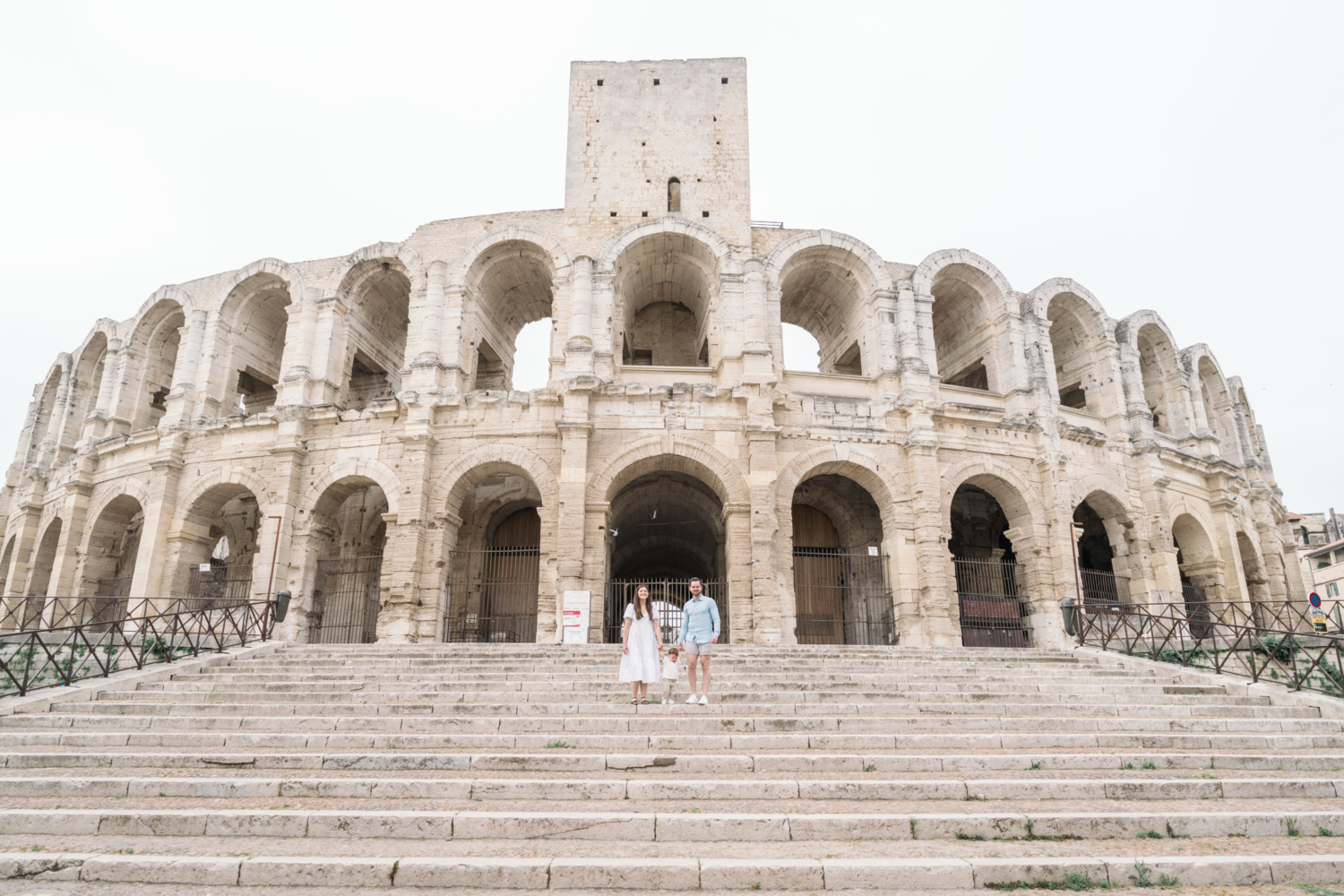 young family pose at roman amphitheater in arles france