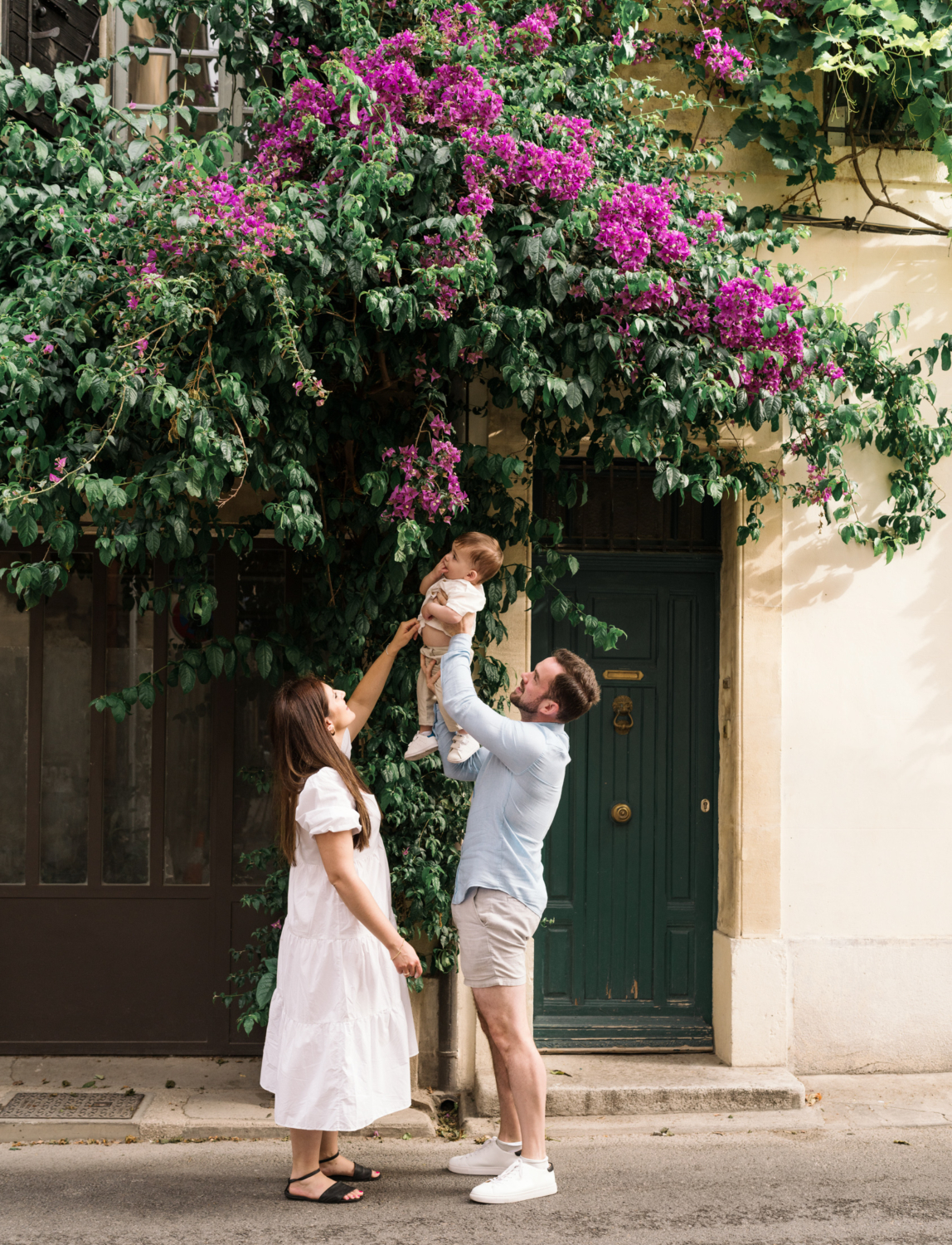 young mom and dad show baby flowers in arles france