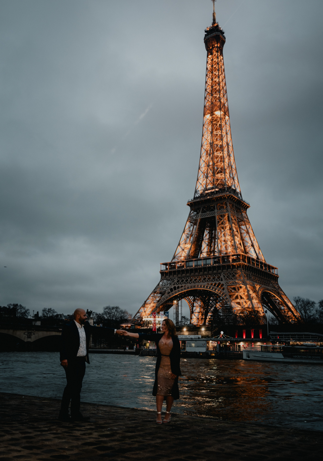 newly engaged couple dance with view of eiffel tower after their engagement