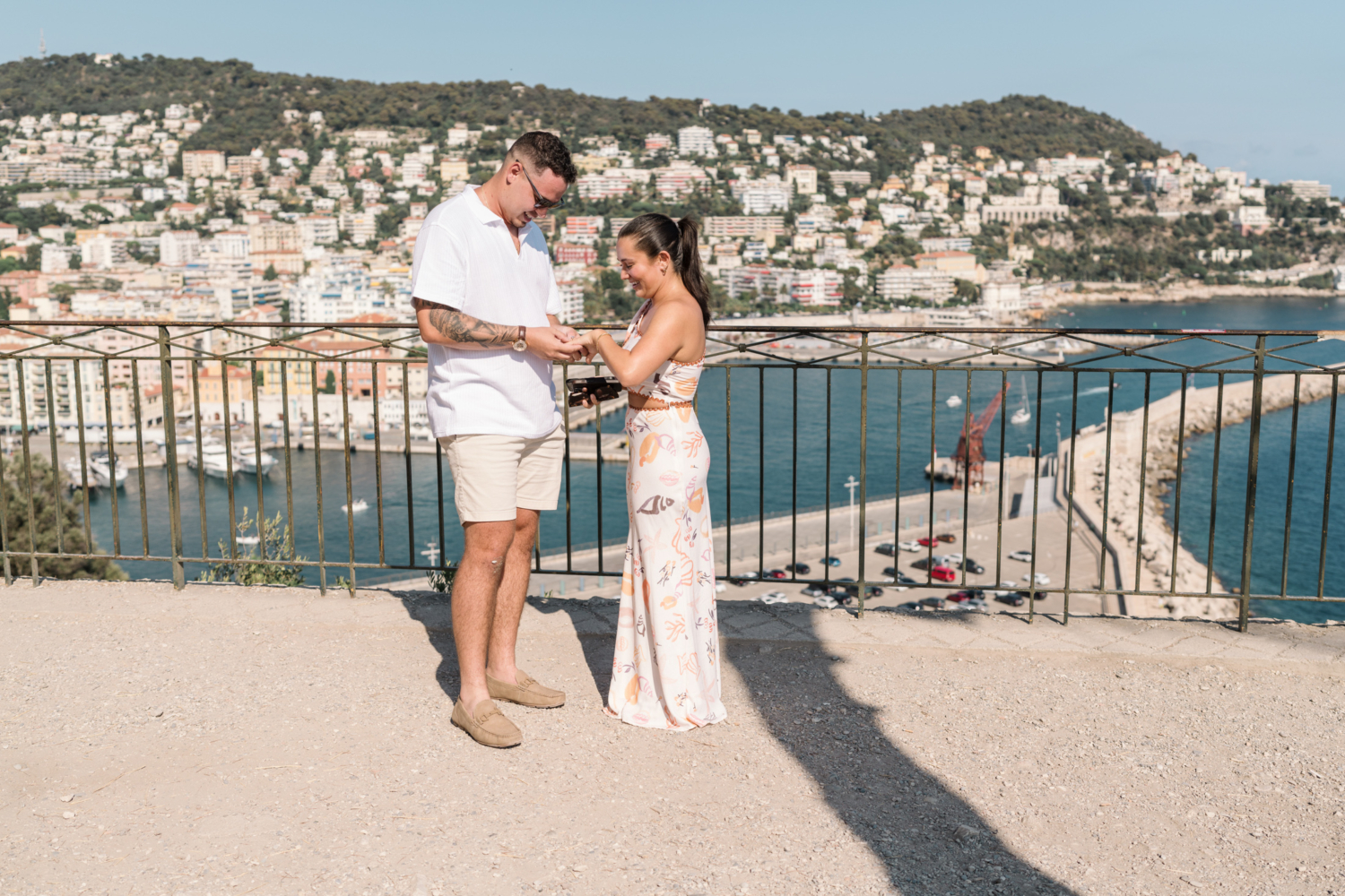 woman admires her new diamond ring with view of sea in nice france