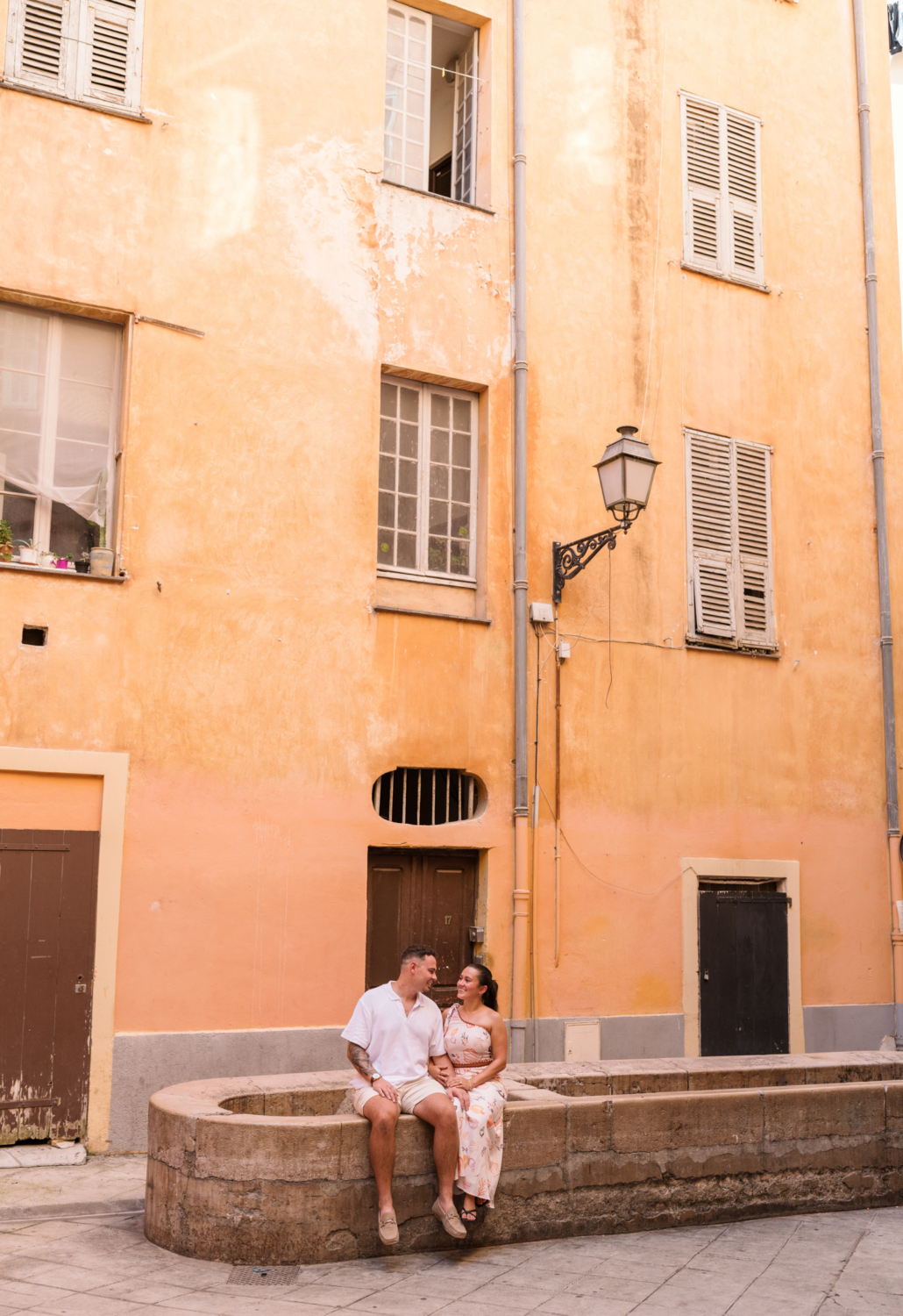 newly engaged couple pose in front of lavoir in old nice france