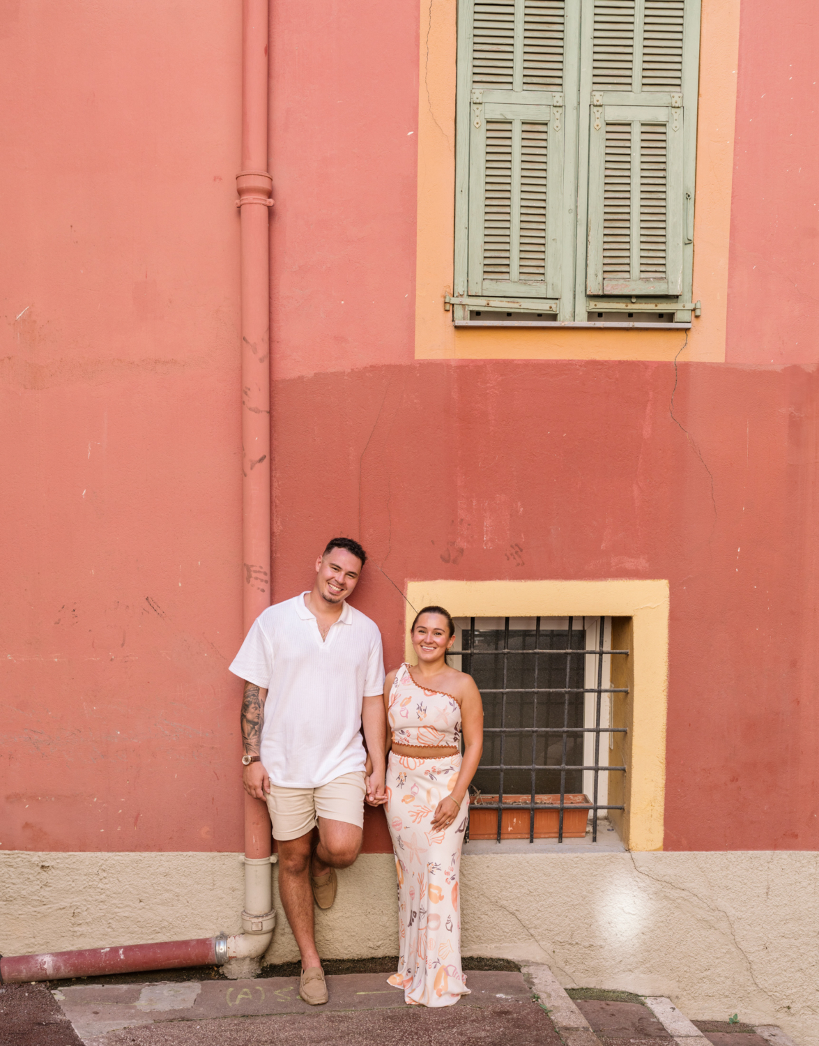 cute newly engaged couple pose in old town nice france