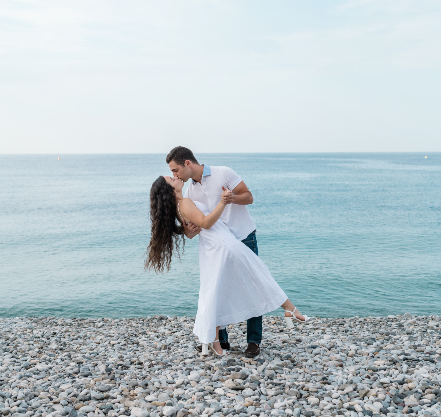 newly engaged couple dance together on beach in nice france