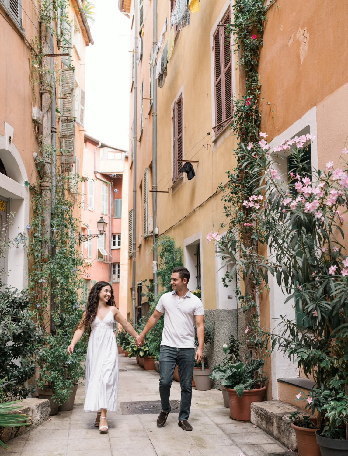 couple walk and laugh in old town nice