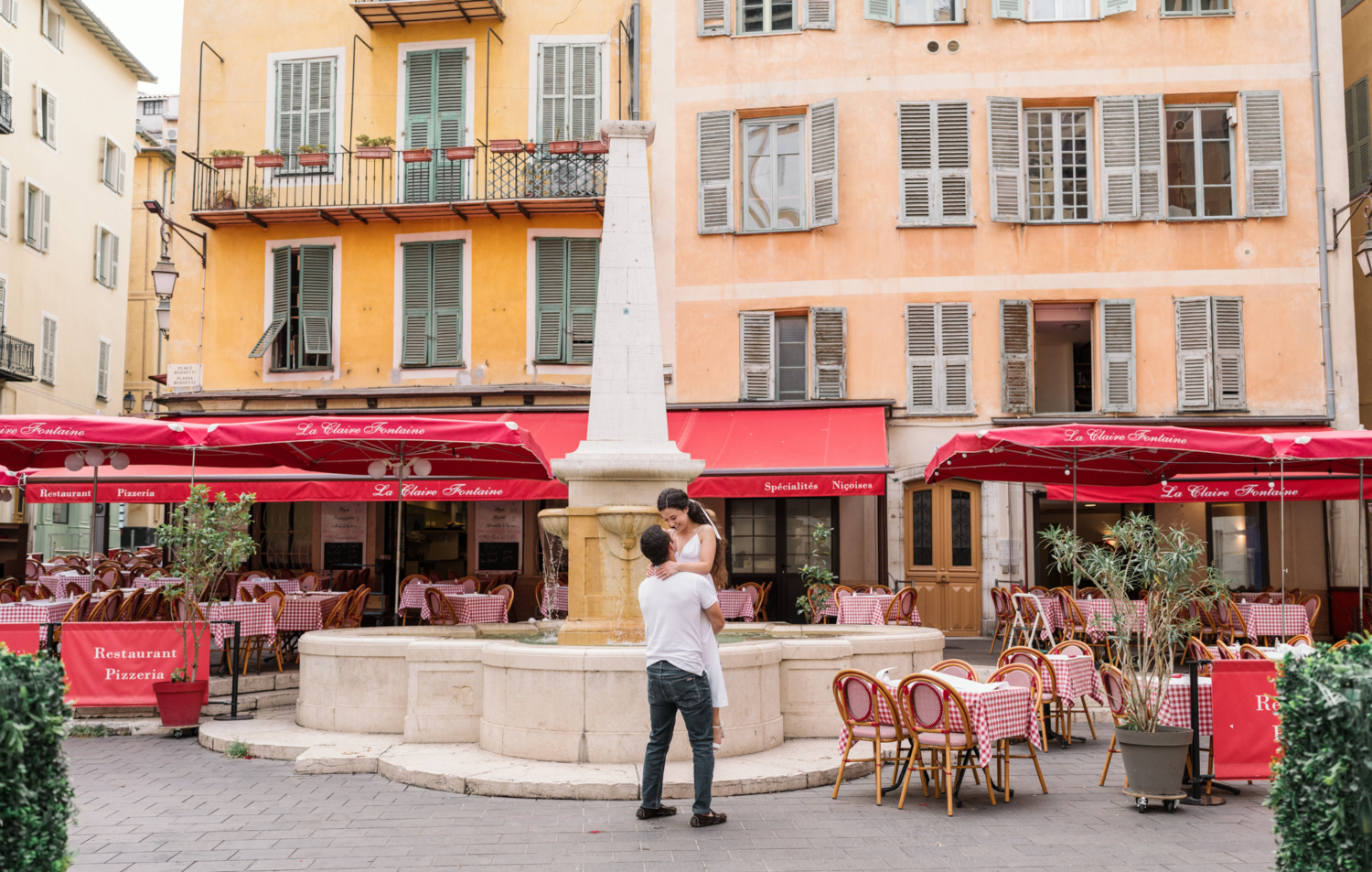 engaged couple dance in front of italian restaurant in old town nice france